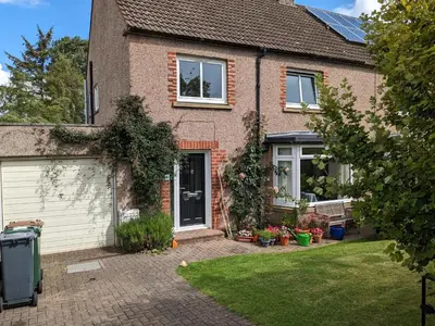 a brick house with a door and a yard at Private room with terrace and free parking in Edinburgh