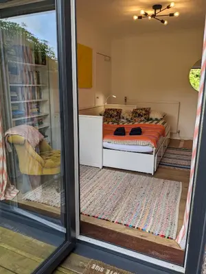 a view of a bedroom with a bed through a window at Private room with terrace and free parking in Edinburgh