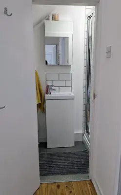 a bathroom with a sink and a mirror at Private room with terrace and free parking in Edinburgh