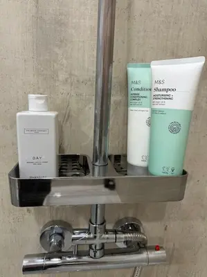 a shelf with toiletries on it in a bathroom at Premium executive Apartment in Dunfermline in Dunfermline