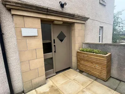 a door to a house with a planter in front at Premium executive Apartment in Dunfermline in Dunfermline