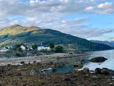 a body of water with houses and a mountain at 2 Bed Cottage Sleeps 2 - Parking Pet Friendly in Dunoon