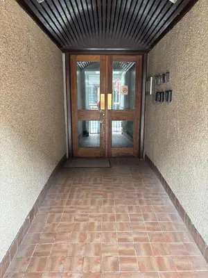 a hallway with a door and a tiled floor at 16 Macgregor court, Oban in Oban