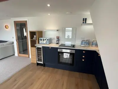 a kitchen with a stove and a counter top at Waverley Apartments, Crow's Nest in Gourock