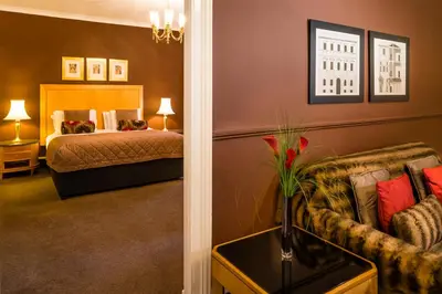 a hotel room with a bed and a couch at Millennium Hotel Glasgow in Glasgow