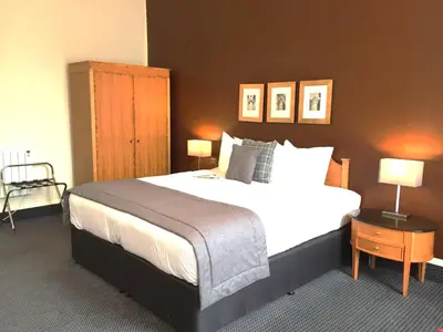 a bedroom with a large bed and two lamps at Millennium Hotel Glasgow in Glasgow