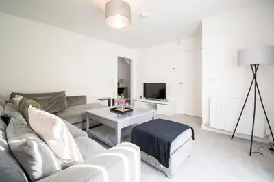 a living room with a couch and a table at Beautiful Glasgow South Home - Pass the Keys in Glasgow