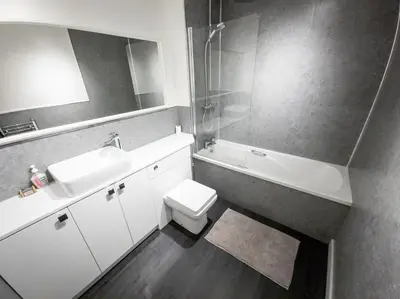 a bathroom with a sink and a toilet and a mirror at Tranquil 2Bed/2Bath Duplex Falkirk in Falkirk