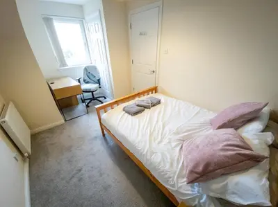 a bedroom with a bed with two towels on it at Tranquil 2Bed/2Bath Duplex Falkirk in Falkirk
