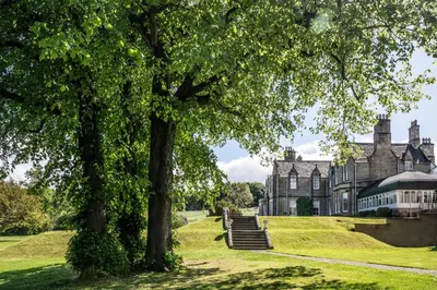 an old mansion with trees in front of it at Norton House Hotel & Spa, Edinburgh in Ingliston
