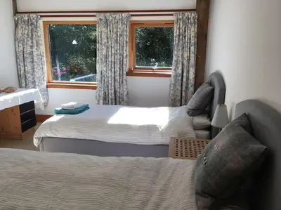 a bedroom with two beds and a window at Beautiful Award-Winning Rural Home in Dolphinton