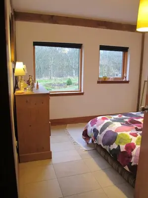 a bedroom with a bed and a window at Beautiful Award-Winning Rural Home in Dolphinton