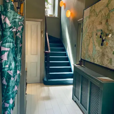 a hallway with a staircase with a blue stair case at Ben A'an House in Callander