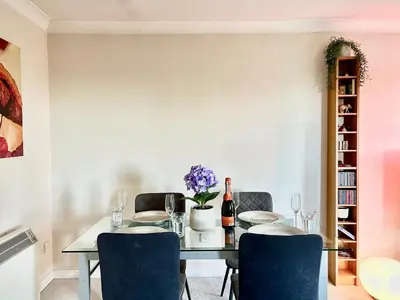 a dining room with a table and chairs at Spekman's 3 Bedroom Ap - 20min Glasgow & Edinburgh in Falkirk