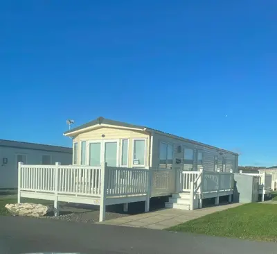 a mobile home with a porch and a white fence at Static Caravan Saltcoats Ayrshire Scotland 3 bedroom balcony in Stevenston