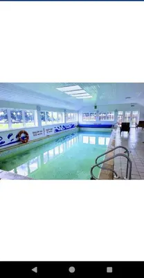 a large swimming pool in a large building at Loch's Heaven 67 in Kirkcowan