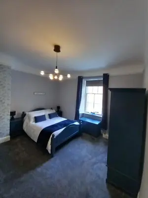 a bedroom with a large bed and a window at The Nifty Nook in Campbeltown