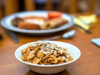a bowl of granola and toast on a table at Corstorphine Lodge Hotel in Edinburgh