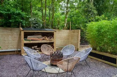 a group of chairs and a table in a garden at The Ultimate Luss Retreat in Luss