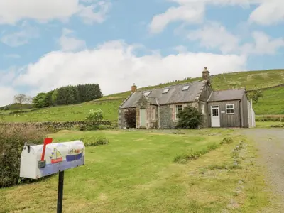 an old house in the middle of a field at Prince's Cottage in Thornhill