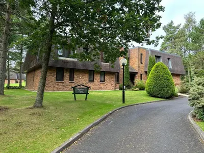 a house with a street sign in front of it at One Dunbar Court Gleneagles Village in Auchterarder