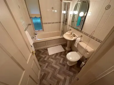 a bathroom with a sink and a toilet and a tub at One Dunbar Court Gleneagles Village in Auchterarder