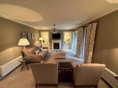 a living room with a couch and a table at One Dunbar Court Gleneagles Village in Auchterarder