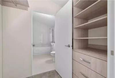 a white bathroom with a toilet and a shower at Rivers Edge in Dollar