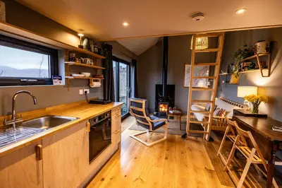 a kitchen with a sink and a counter with a window at Jura - The Black Hut in Isle of Jura