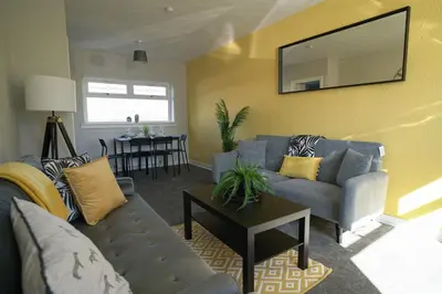 a living room with a couch and a table at McCracken House in Uddingston