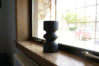 a black candle sitting on a window sill at Sauchie House in Sauchie