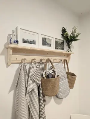 a shelf with baskets and bags on a wall at The Cottage @ 59 in Colmonell