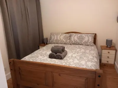 a bed with two stuffed animals sitting on it at The WEE HOUSE Balvicar Isle of Seil in Balvicar