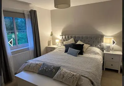 a bedroom with a large bed and a window at Beautiful cosy 2-bedroom entire house in Connel, near Oban in Connel
