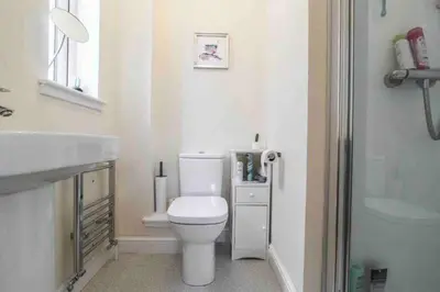 a bathroom with a white toilet and a sink at Beautiful cosy 2-bedroom entire house in Connel, near Oban in Connel
