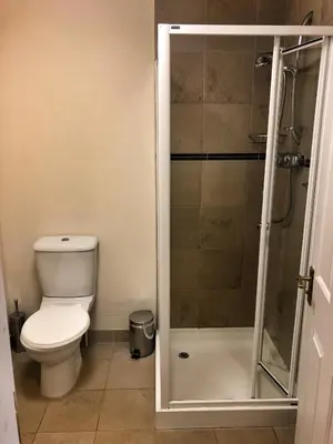 a bathroom with a toilet and a shower at The Arran Lodge & Arran Sleep Huts in Lamlash