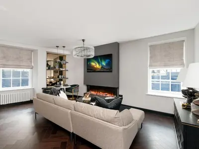 a living room with a couch and a fireplace at Luxury Romantic West-End Apartment With Jacuzzi Spa Bath in Edinburgh