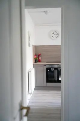 a kitchen with a oven and a clock on the wall at 2 BDR Apt By Caledonia Luxe Stays Short Lets & Serviced Accommodation Airdrie in Airdrie