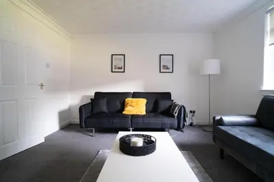 a living room with a couch and a coffee table at 2 BDR Apt By Caledonia Luxe Stays Short Lets & Serviced Accommodation Airdrie in Airdrie