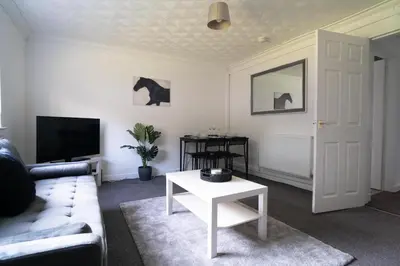 a living room with a couch and a table at 2 BDR Apt By Caledonia Luxe Stays Short Lets & Serviced Accommodation Airdrie in Airdrie