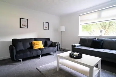 a living room with two couches and a table at 2 BDR Apt By Caledonia Luxe Stays Short Lets & Serviced Accommodation Airdrie in Airdrie