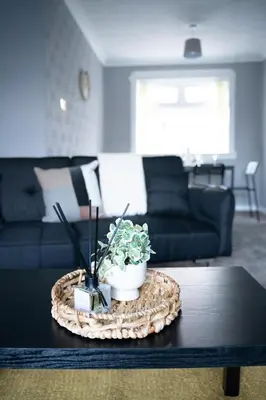 a living room with a table with a plant on it at Darmeid House in Hartwood