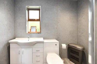 a bathroom with a sink and a toilet and a mirror at North Blairkip Eildon in Sorn