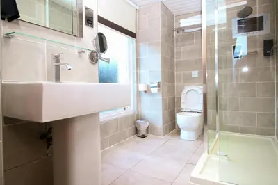 a bathroom with a sink and a toilet at Albion Hotel in Glasgow