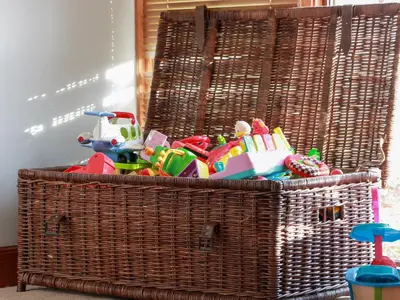 a wicker basket filled with toys in a room at Shieldhill Farm House in Falkirk