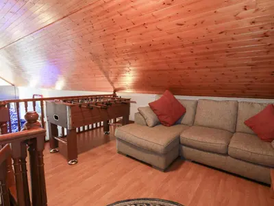 a living room with a couch and a pool table at Shieldhill Farm House in Falkirk