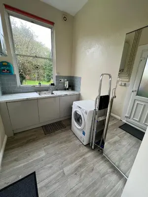 a laundry room with a washing machine and a sink at CAMPBELL 100 DUNFERMLINE in Fife
