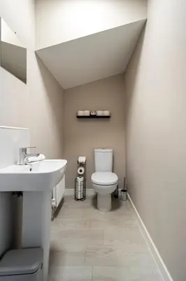 a bathroom with a toilet and a sink at Superb 3 Bed Home Away from Home in Glasgow, just off M8 with free parking in Steps