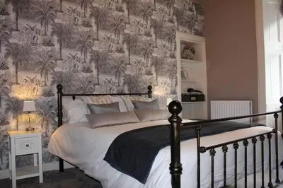 a bedroom with a large bed with a wall mural at Cameronian Apartment in Stirling