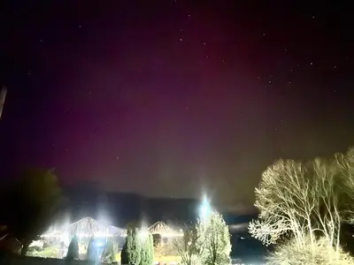 a night time view of a city with a sky filled with stars at Loch View Luxury Pod in Connel